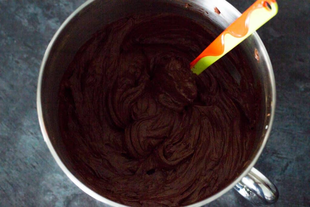 No bake chocolate cheesecake filling in a stand mixer bowl with a spatula