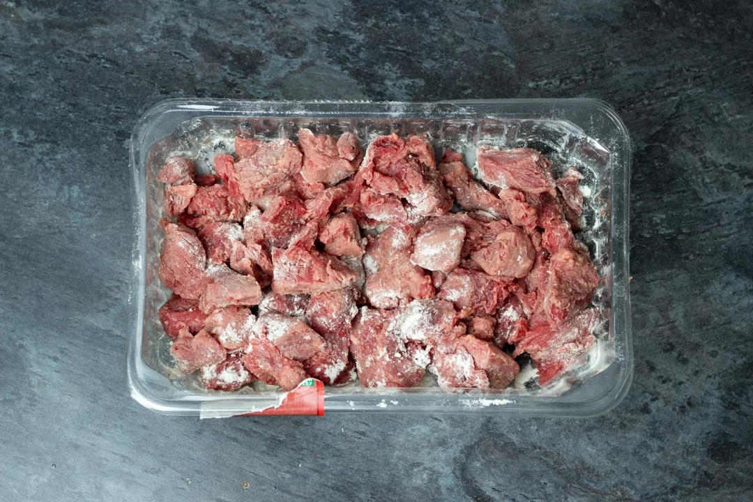 beef coated in flour in a tray
