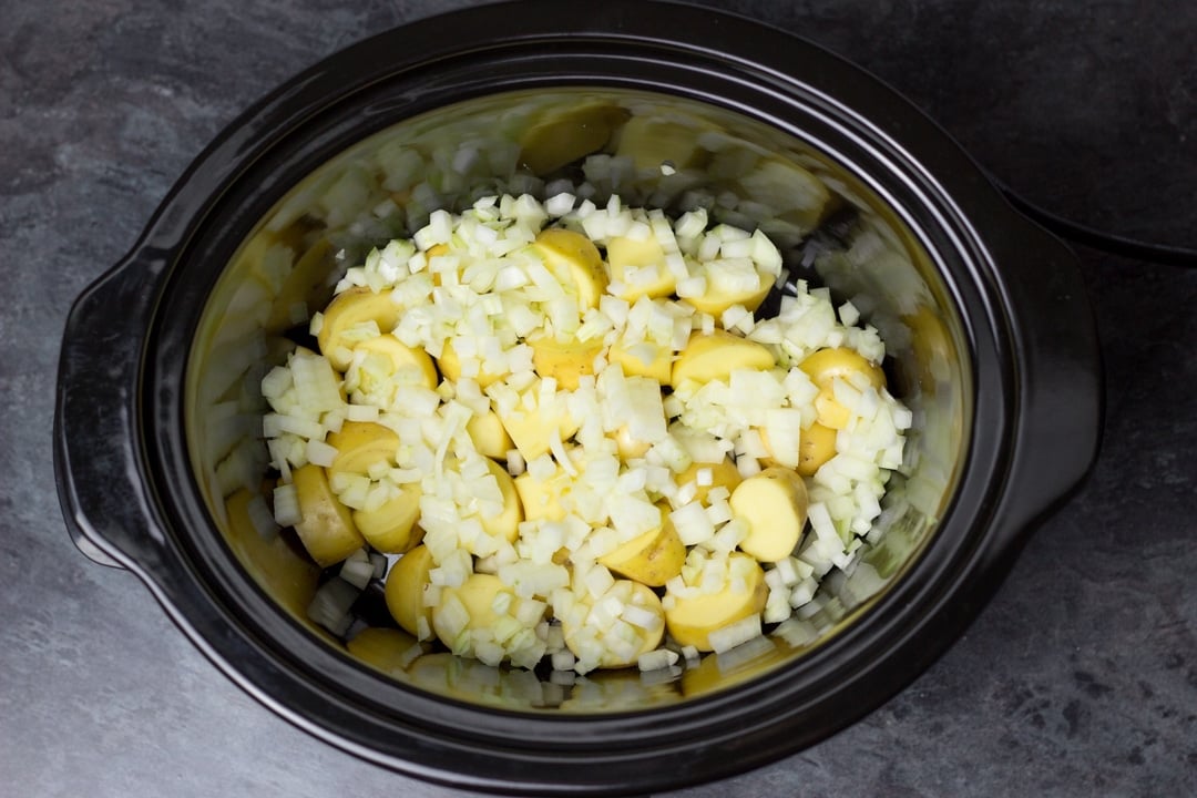 potatoes and onion in a slow cooker