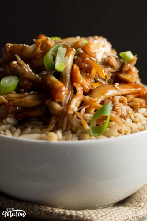 Chicken teriyaki recipe: chicken teriyaki in a bowl with rice sprinkled with sesame seeds and spring onion