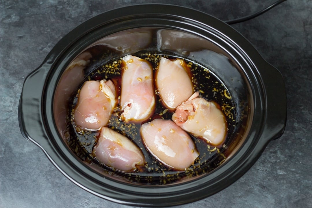 Chicken teriyaki recipe: chicken thighs in a slow cooker covered in teriyaki sauce