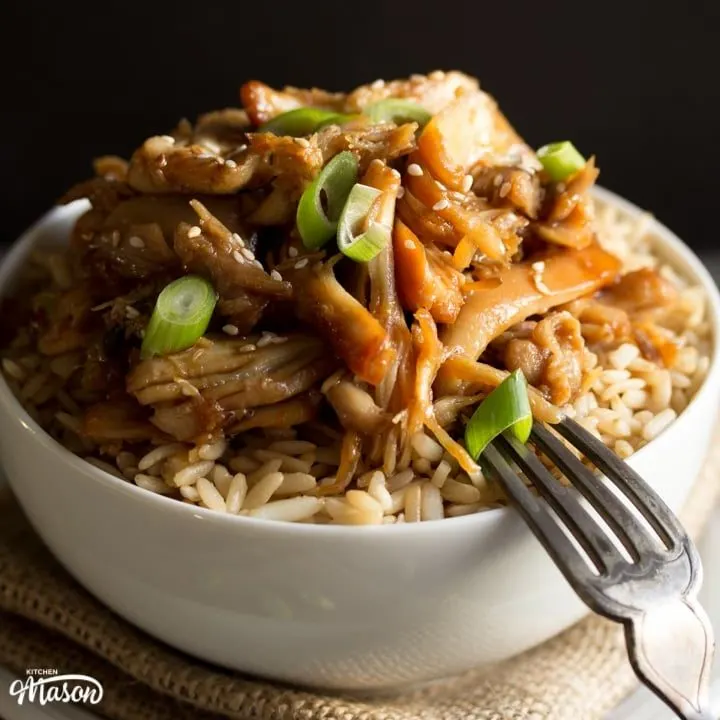 Chicken teriyaki recipe: chicken teriyaki in a bowl with rice sprinkled with sesame seeds and spring onion