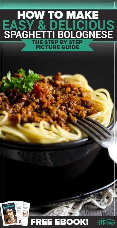 Easy spaghetti bolognese in a black bowl with a fork, topped with parsley