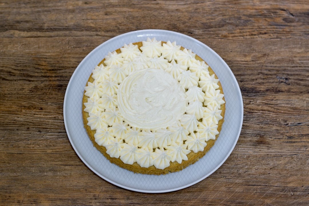 dairy free / vegan lemon bottom cake layer on a plate with frosting on top