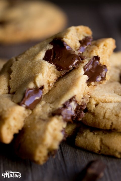 vegan chocolate chip cookies broken in half with melting chocolate chips