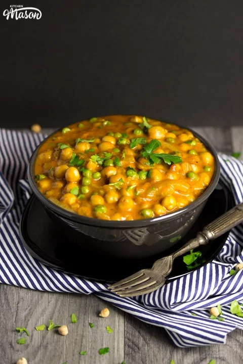 coconut chickpea curry in a bowl with parsley scattered on top