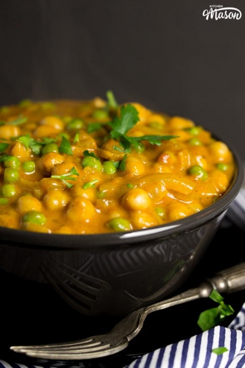 coconut chickpea curry in a bowl with parsley scattered on top