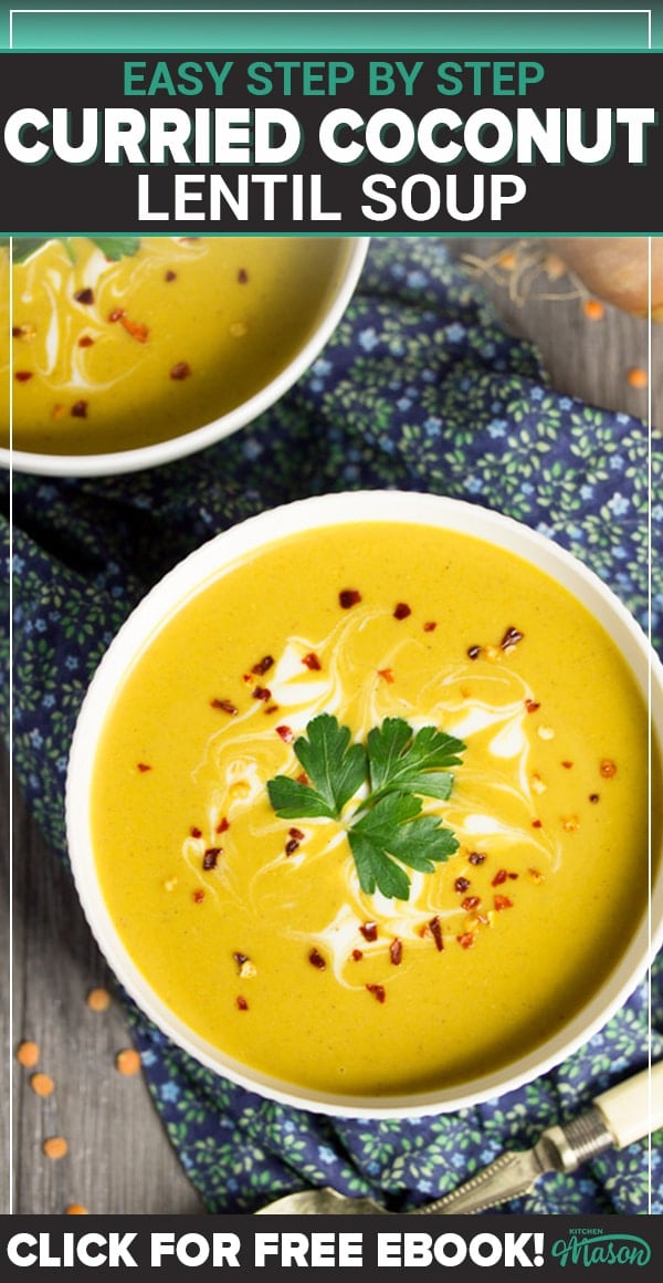 curried coconut lentil soup in a bowl with parsley and chilli flakes on top