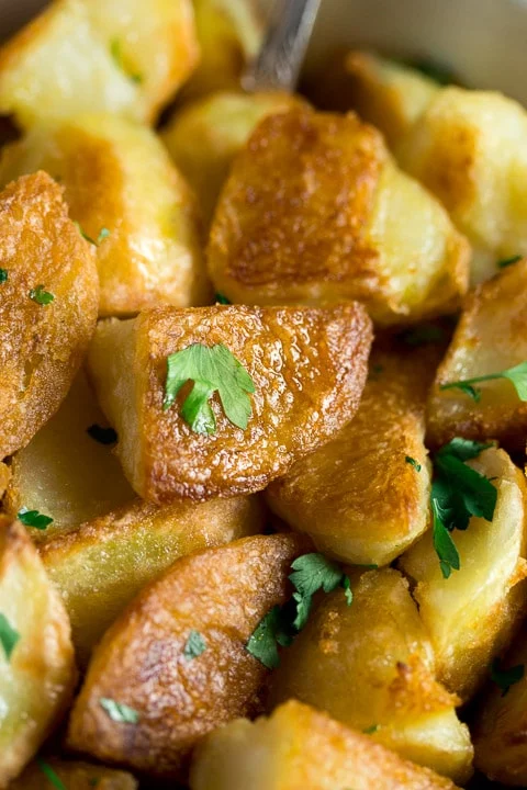 crispy roast potatoes with parsley scattered on top