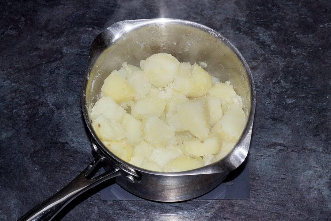 drained boiled potatoes in a saucepan