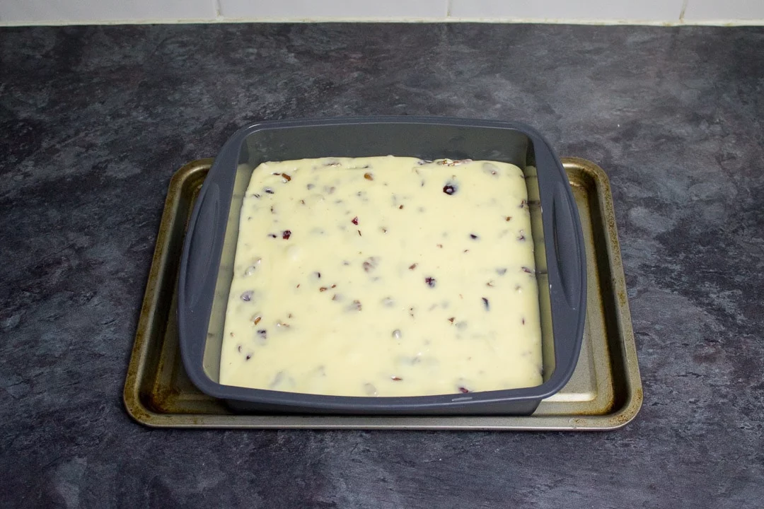 white chocolate pecan cranberry fudge in a silicone pan