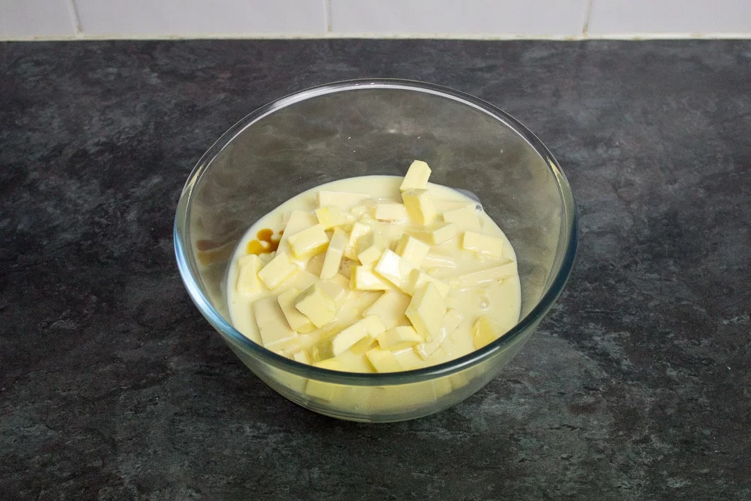 white chocolate, butter, condensed milk and vanilla in a glass bowl