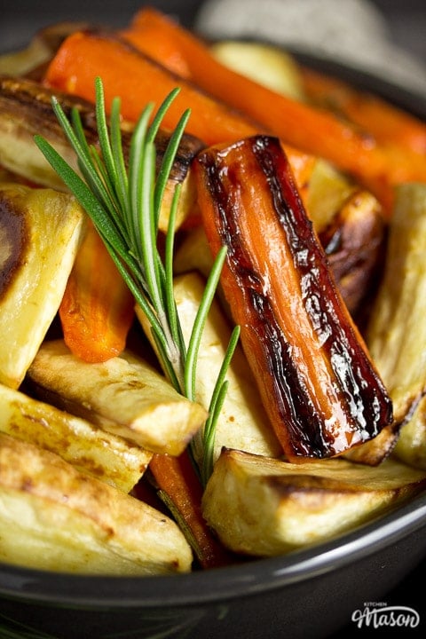 Honey roast parsnips and carrots with rosemary in a bowl