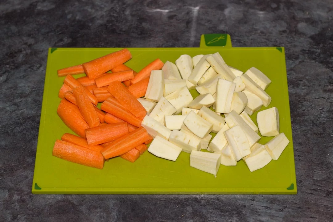 chopped carrots and parsnips on a chopping board