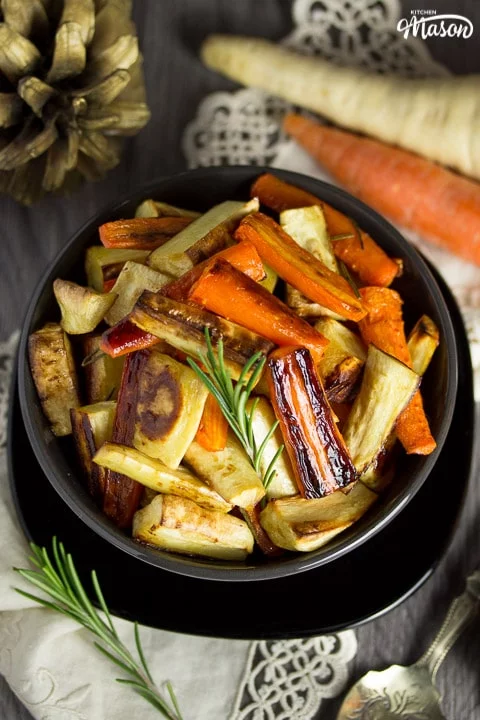Honey roast parsnips and carrots with rosemary in a bowl