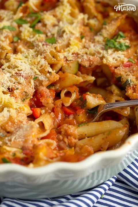 vegetable pasta bake in an oven proof dish with a spoon