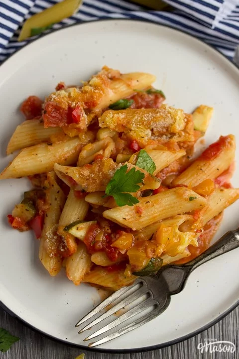 vegetable pasta bake on a plate with a fork