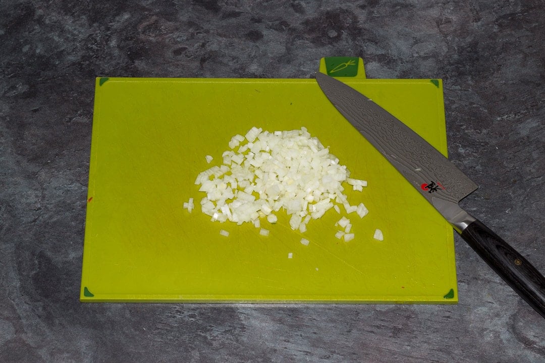 onion finely chopped on a chopping board