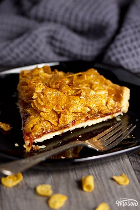 Close up view of a slice of cornflake tart on a plate