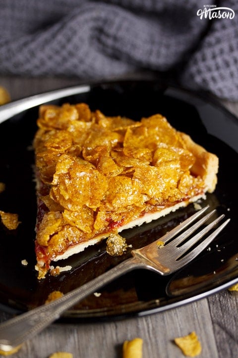 Front view of a cornflake tart slice with a fork