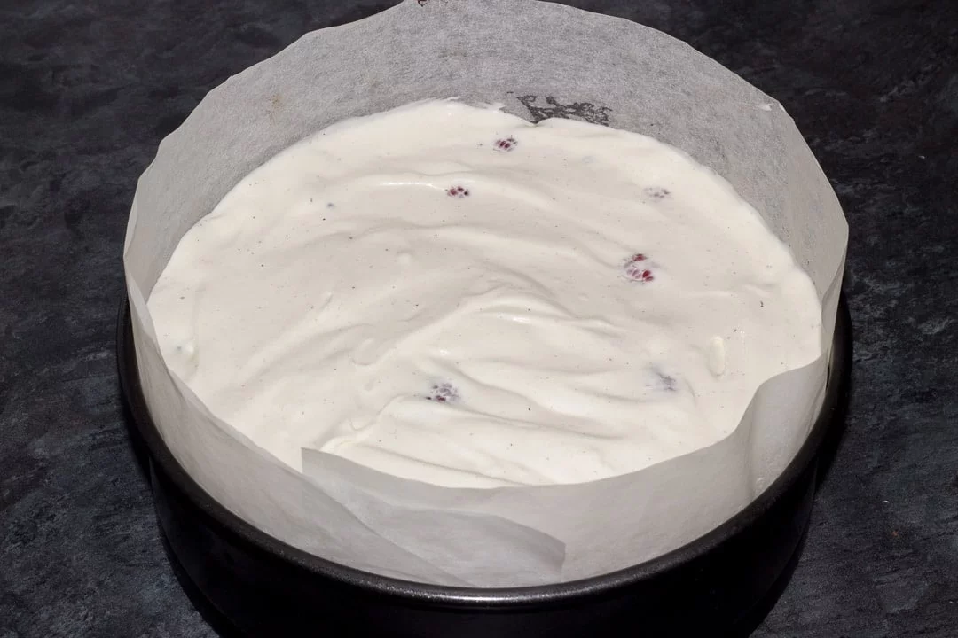 vegan gluten free raspberry brownie ice cream cake in a lined baking tin
