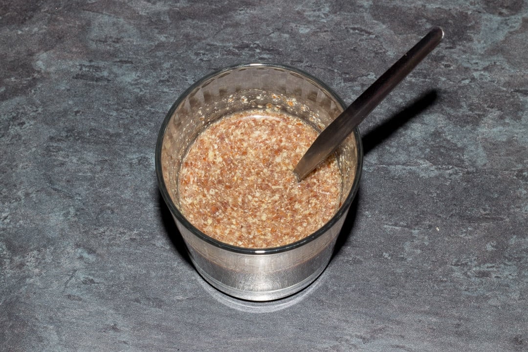 flax egg in a small glass with a metal spoon