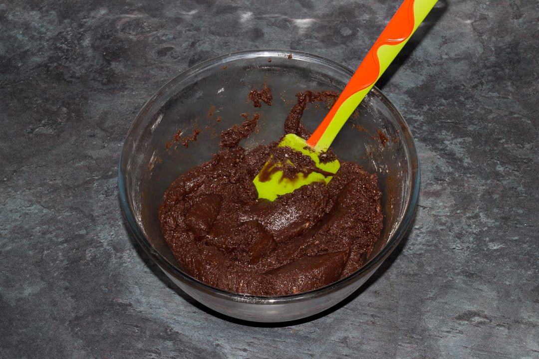 vegan gluten free raspberry brownie batter in a glass bowl