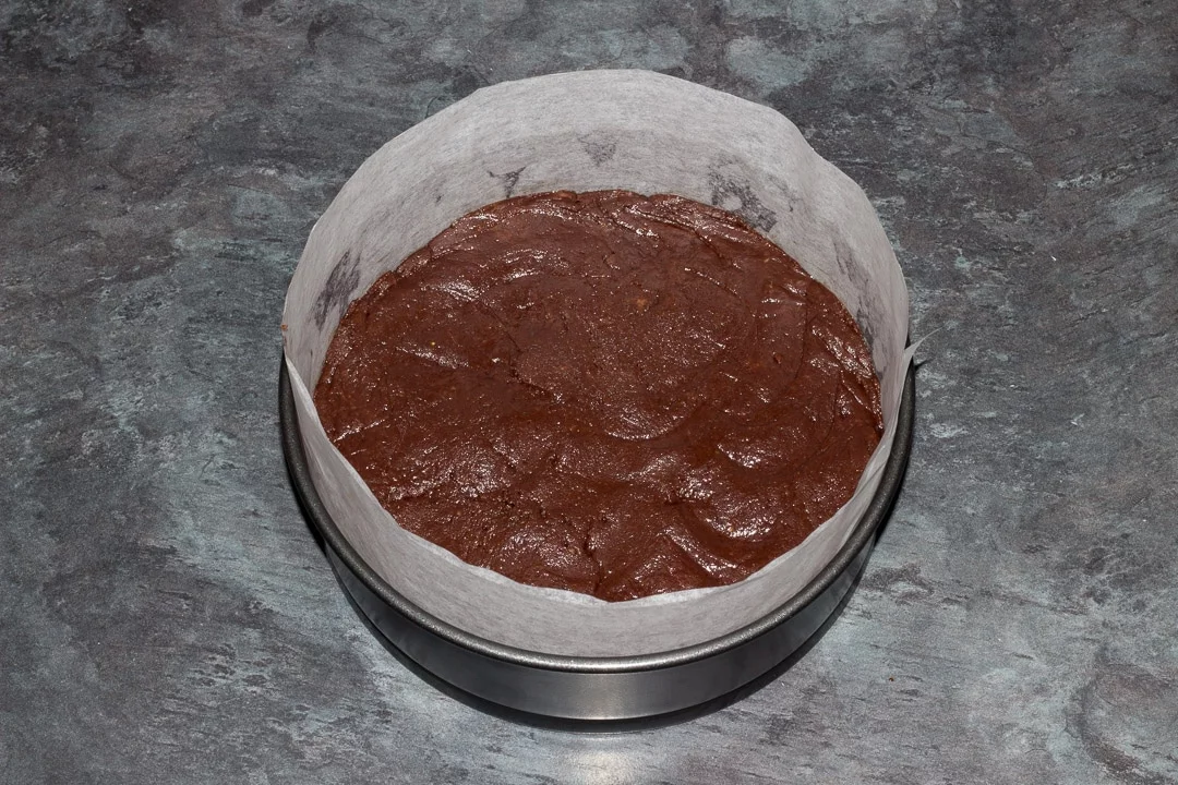 vegan gluten free raspberry brownie batter in a prepared baking tin