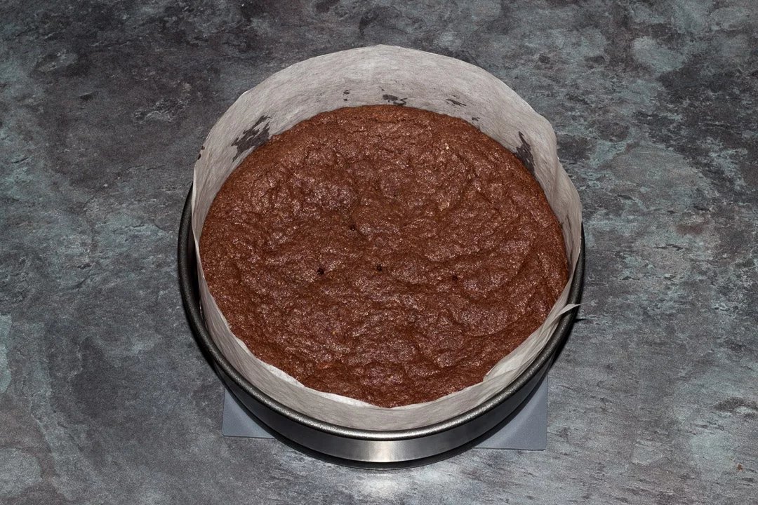 Baked vegan gluten free raspberry brownie in a baking tin