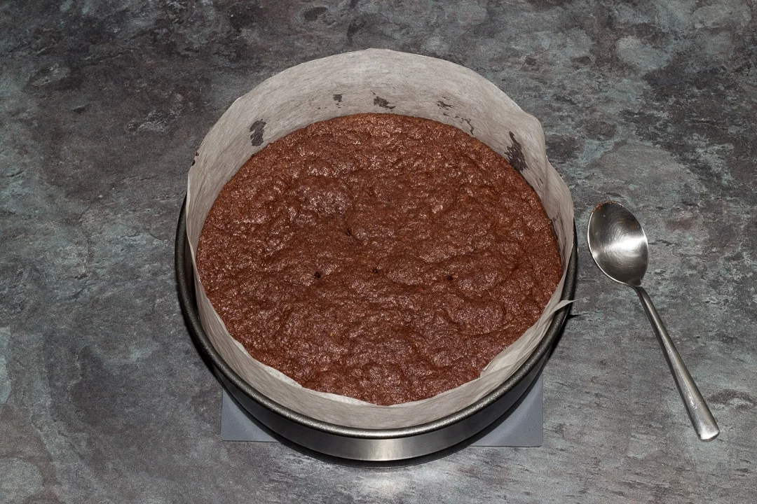 Baked vegan gluten free raspberry brownie in a baking tin