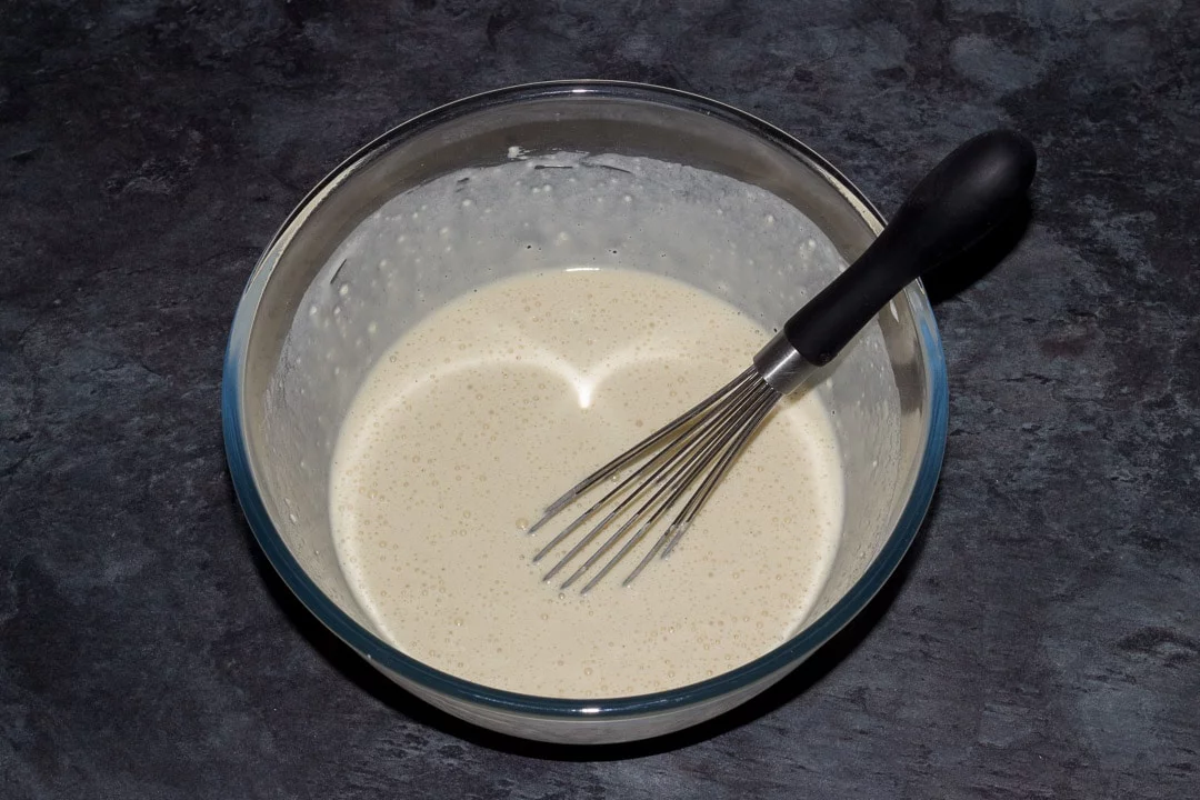 vegan pancake batter in a large bowl with a whisk