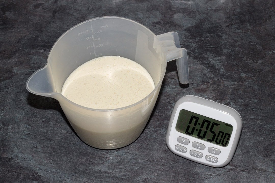 vegan pancake batter in a jug with a timer saying 5 minutes