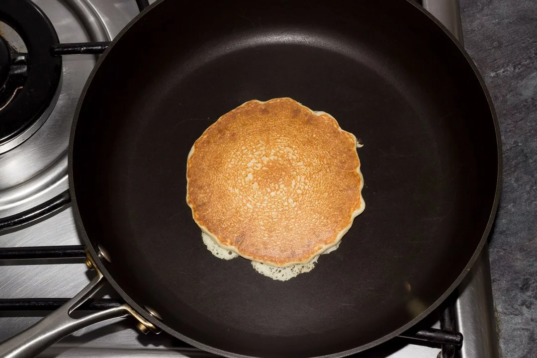 golden vegan pancake in a frying pan