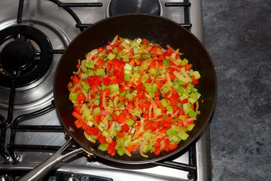 onion, red pepper, celery, ginger and chilli frying in a frying pan