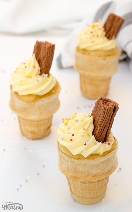 3 ice cream cones filled with cake, topped with icing and chocolate flakes. Cupcakes that look like ice creams.