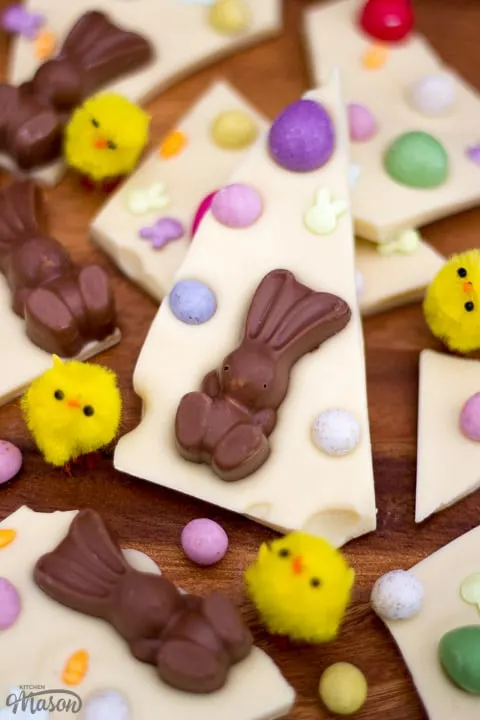 White Chocolate Easter Bark broken up on a chopping board with little yellow chicks