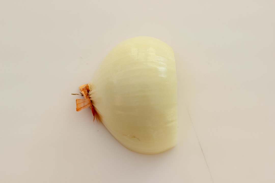 A halved, peeled onion