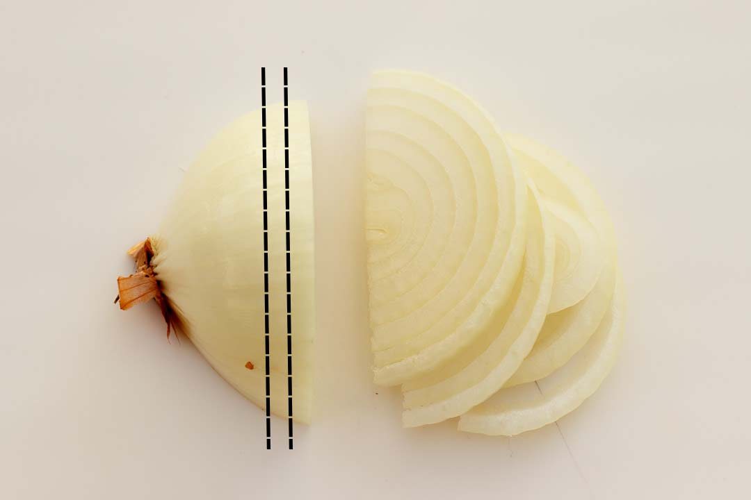 Half a peeled onion that's been sliced