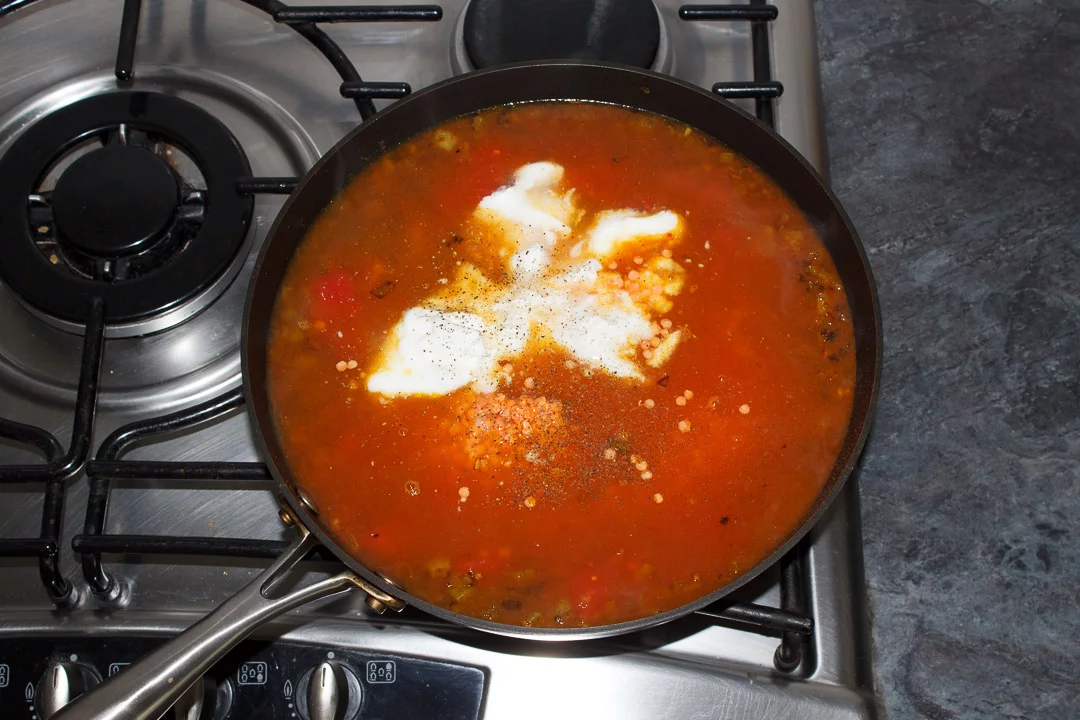 Lentil dahl cooking in a frying pan