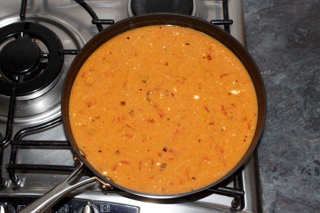 Lentil dahl cooking in a frying pan