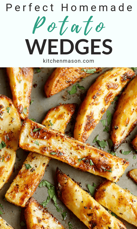 homemade wedges on a baking tray with fresh parsley scattered on top