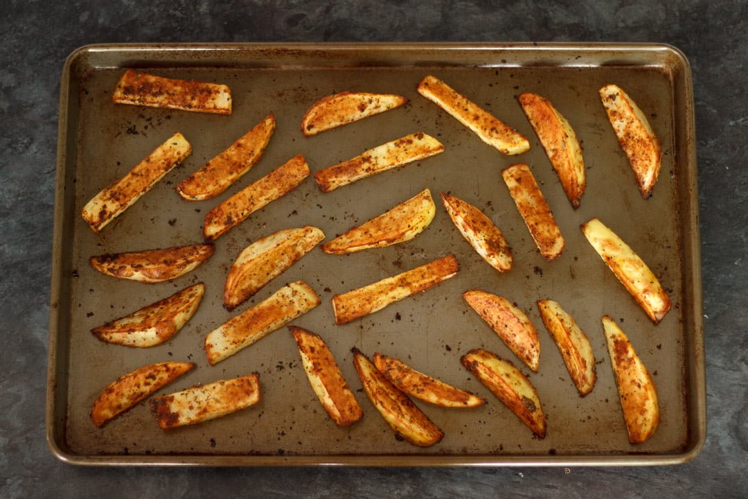 cooked homemade wedges on a baking tray