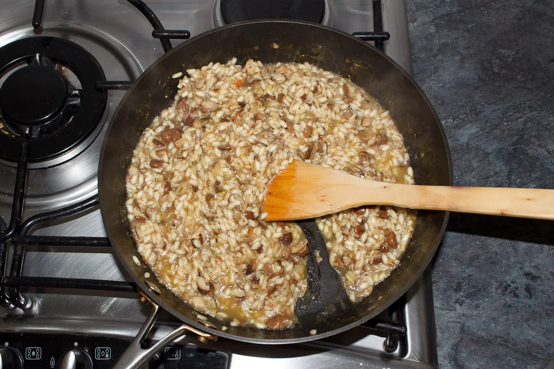 cooked wild mushroom risotto in a large saute pan