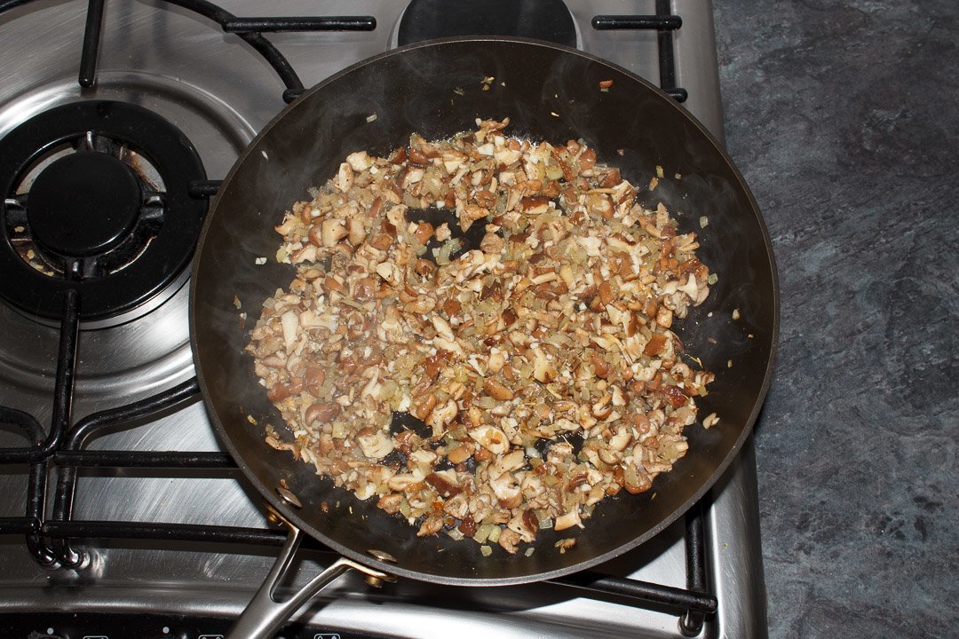 onion, garlic and mushrooms frying in a large saute pan