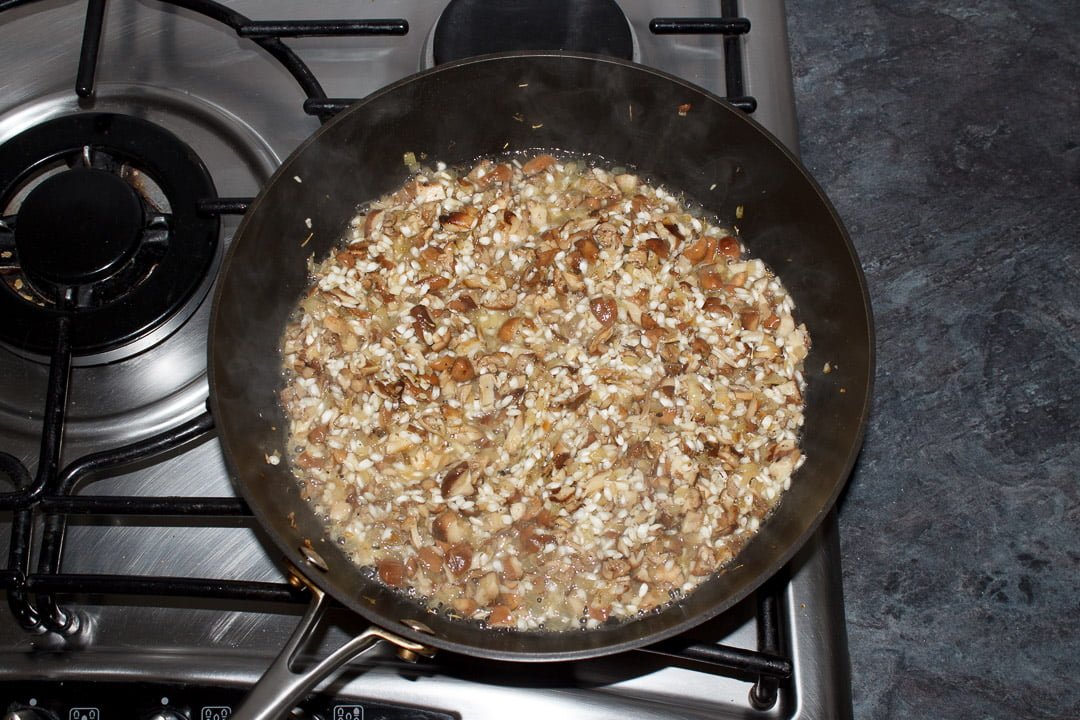 wild mushroom risotto in a large saute pan with white wine