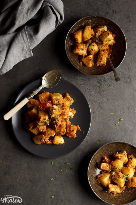 Bombay aloo on a plate with a spoon