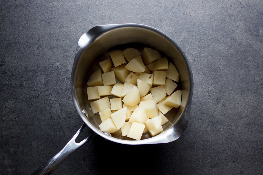 cubed potatoes in a saucepan