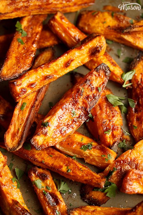 Baked sweet potato wedges on a baking tray