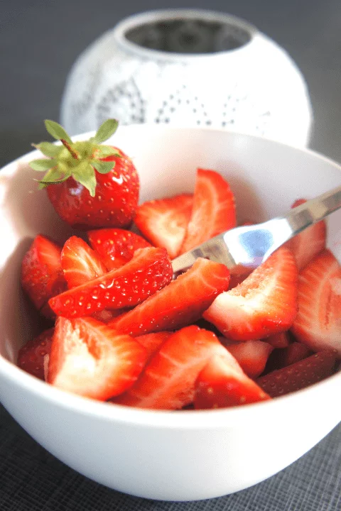 strawberries in a bowl with a fork