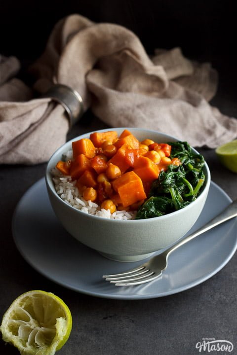 sweet potato chickpea curry in a bowl with rice and spinach